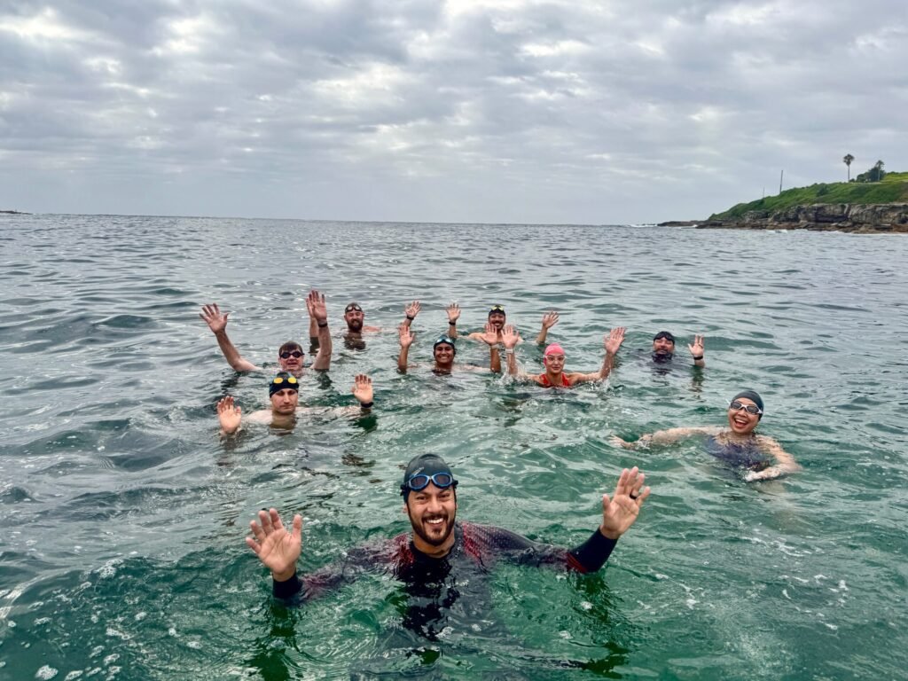 Swimly Ocean Saltwater Squad group swim in the crystal-clear waters of Sydney’s beaches.